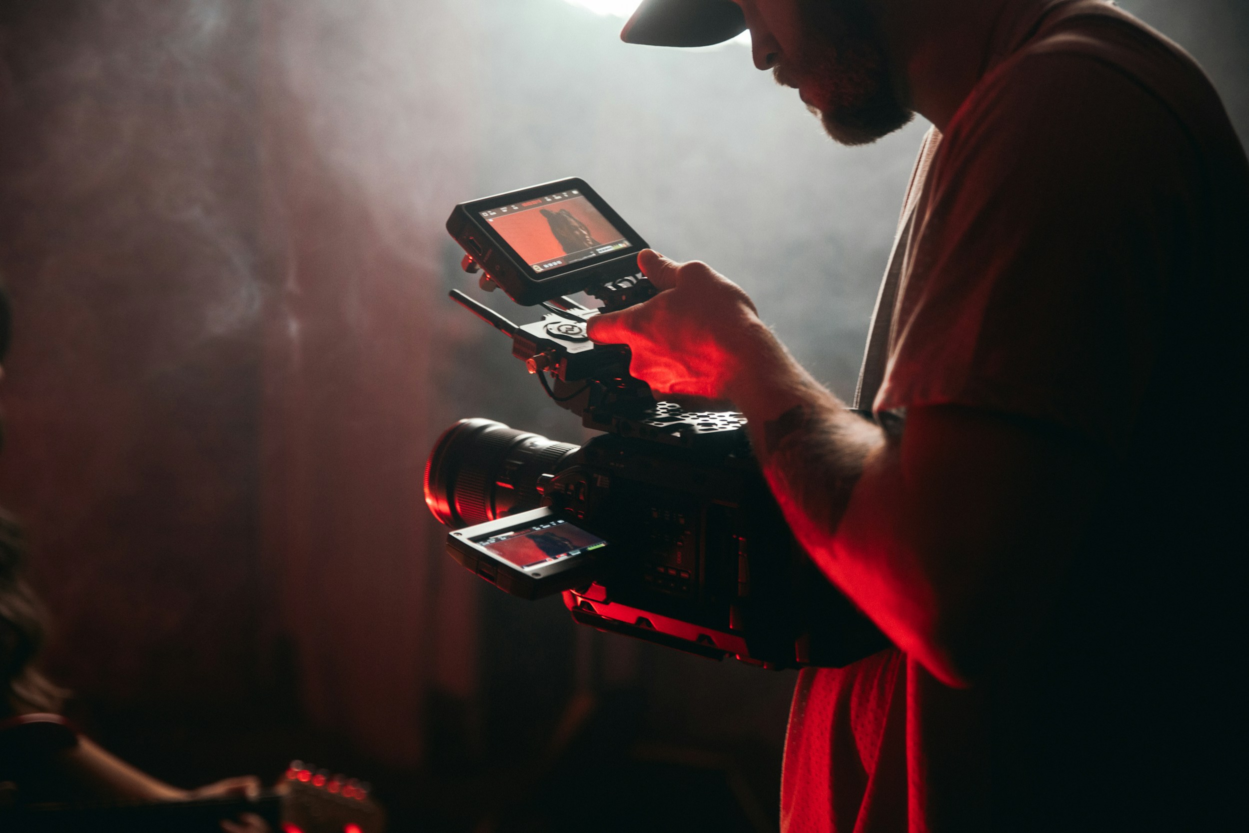 Filmmaker operating cinema camera on set